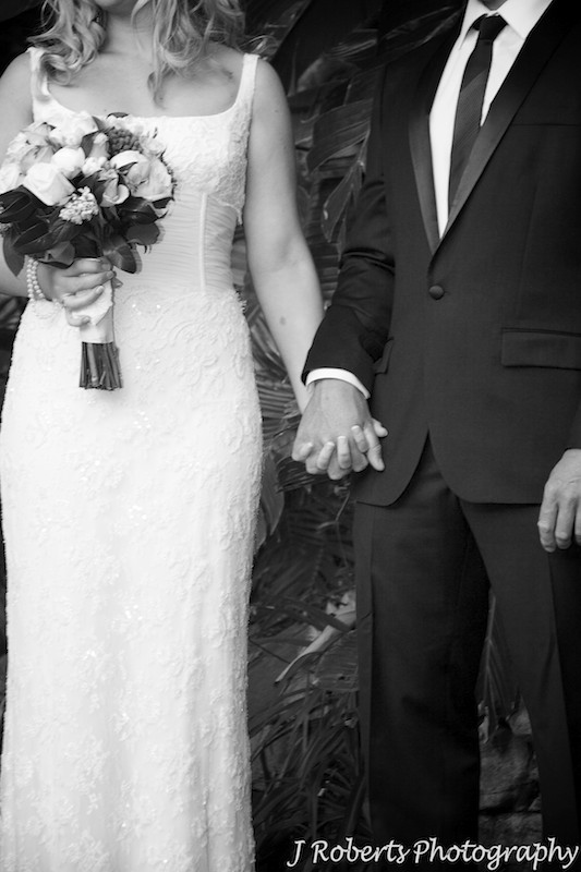 Bride and groom holding hands during wedding ceremony - wedding photography sydney